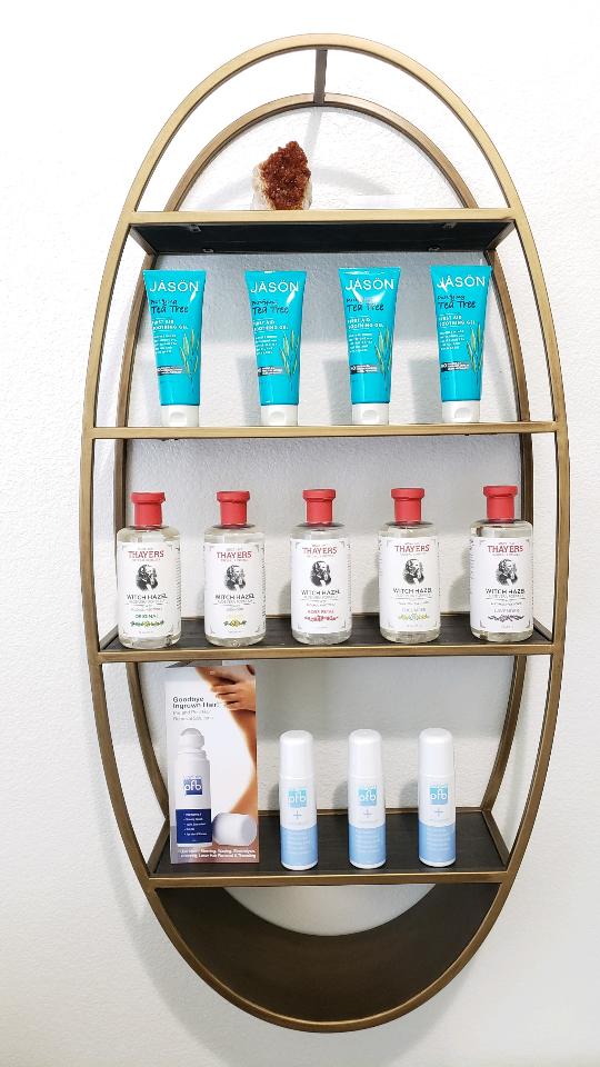 Products on shelf in Juicy Roots Electrolysis office.